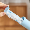 Load image into Gallery viewer, Blue container with cotton wool held by a hand against a blurred background