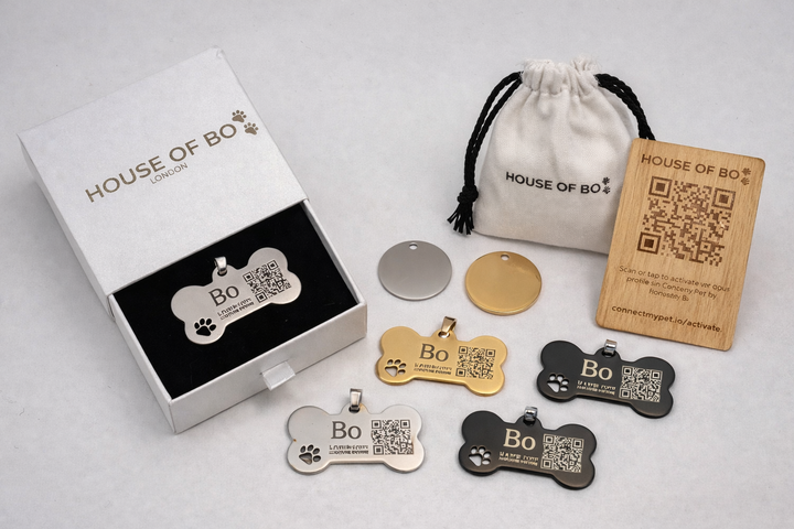 Dog tags with QR codes from 'House of Bo' on a light gray background